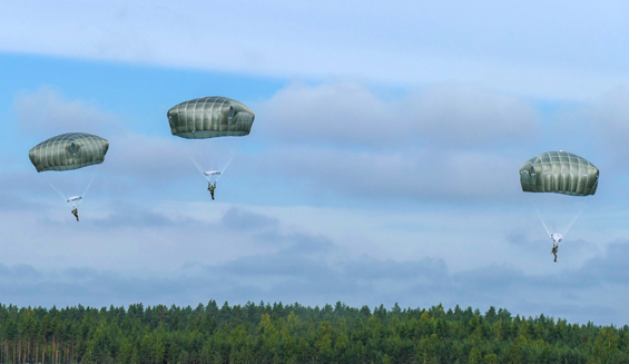 Three soldiers dropping with parachutes