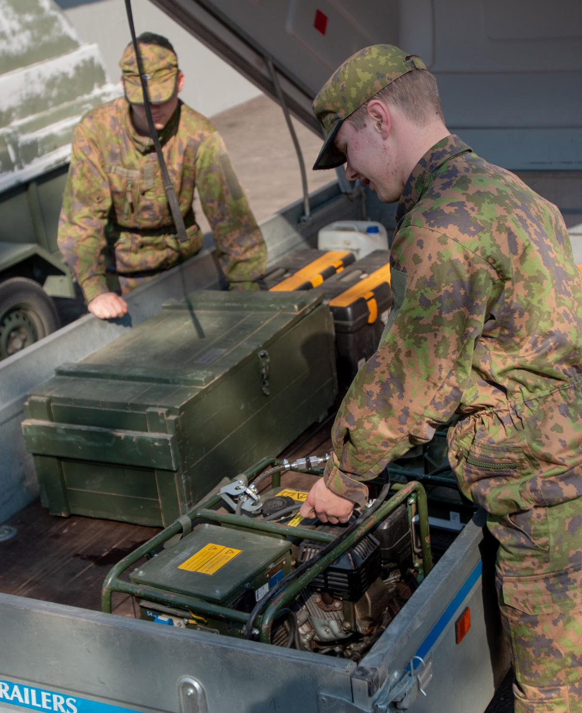 Soldiers loading a trailer with equipment