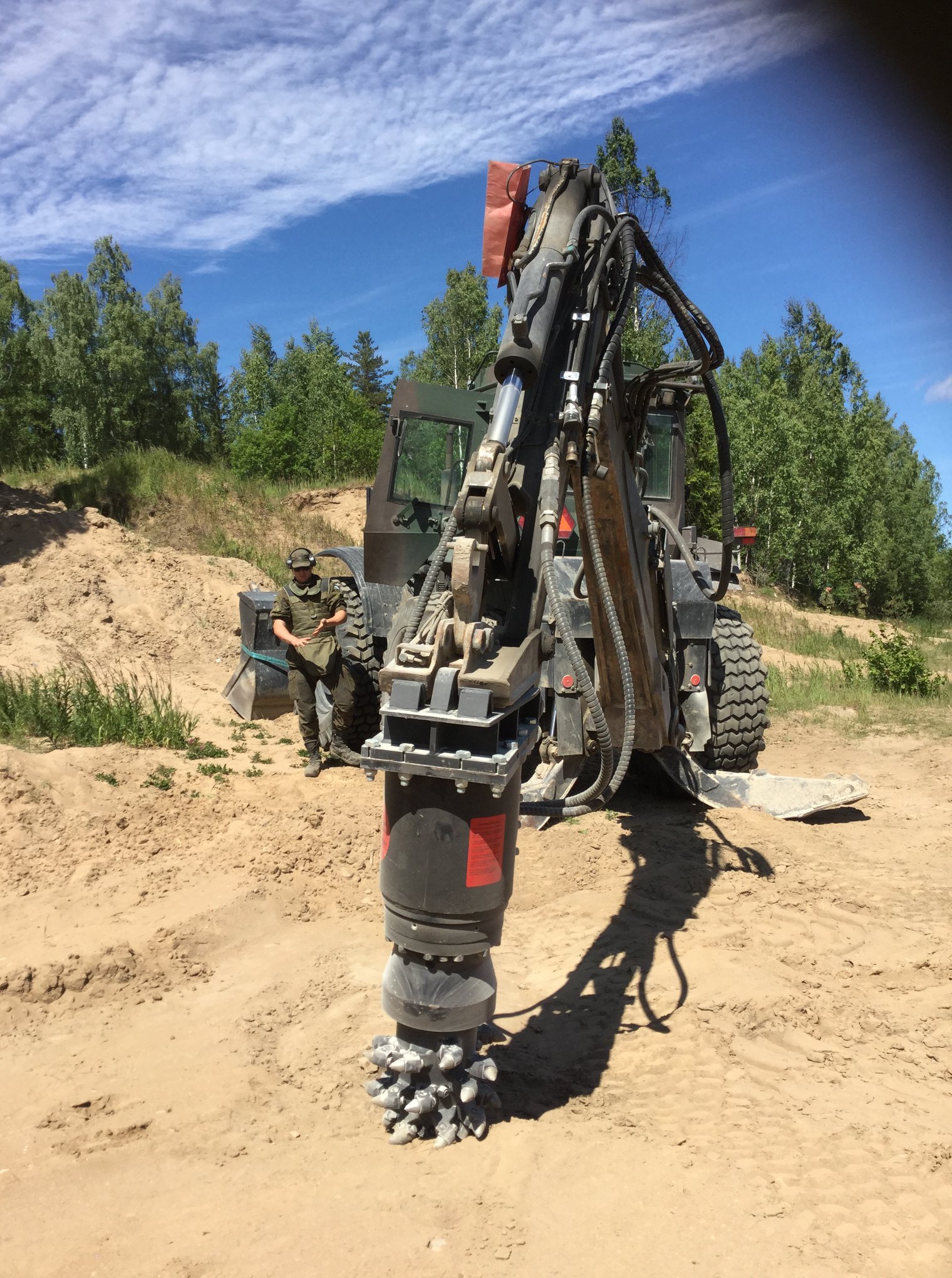 A minesdrill is a spiked large drill attached to an excavator-type vehicle